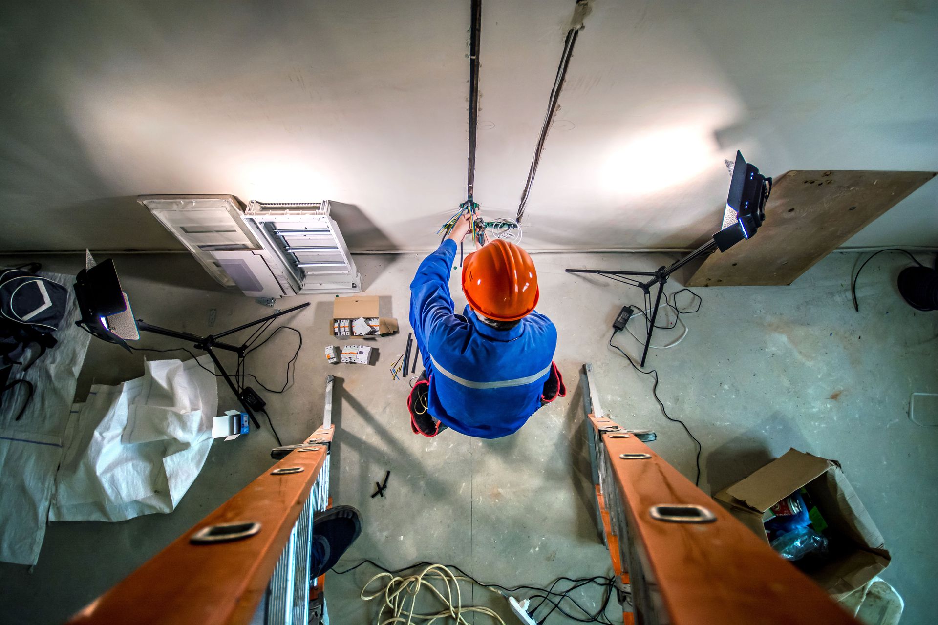 Electrician wiring a ceiling on a jobsite